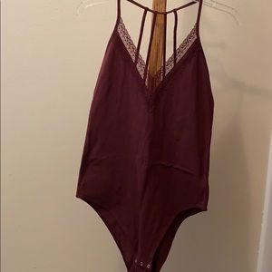 Maroon bodysuit with lace and strappy back. NWOT